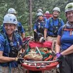 Dog Injured During Hike Carried Down Trail By Rocky Mountain Rescue Group.